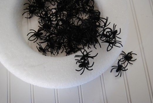 foam wreath and plastic spiders