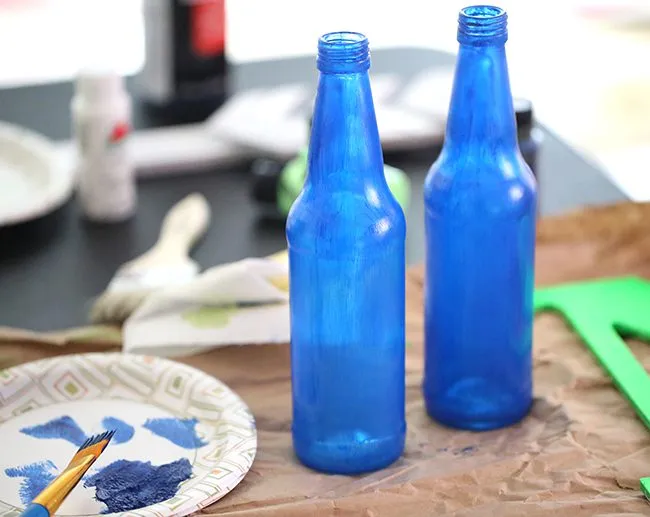 Make your own Red, White & Blue Glass Bottles with this DIY project.