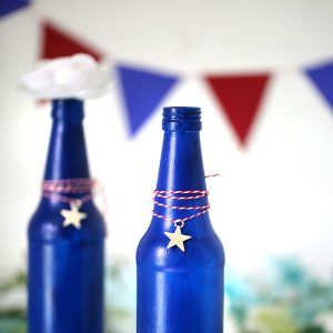 Make your own Red, White & Blue Glass Bottles with this DIY project.