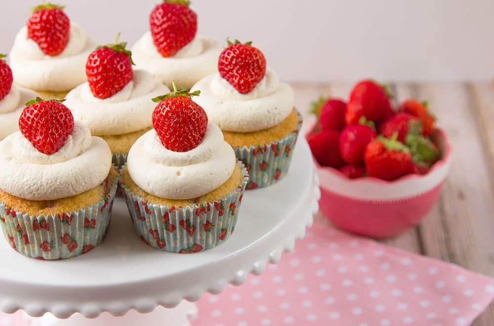 Soft cupcakes filled with chunks of fresh strawberries and topped with sweetened whipped cream and a whole strawberry make these Strawberries and Cream Cupcakes the perfect Summer treat!