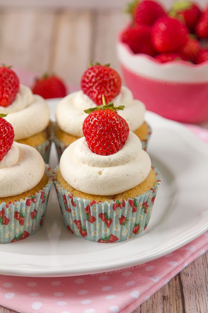 Soft cupcakes filled with chunks of fresh strawberries and topped with sweetened whipped cream and a whole strawberry make these Strawberries and Cream Cupcakes the perfect Summer treat!