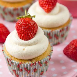 Soft cupcakes filled with chunks of fresh strawberries and topped with sweetened whipped cream and a whole strawberry make these Strawberries and Cream Cupcakes the perfect Summer treat!