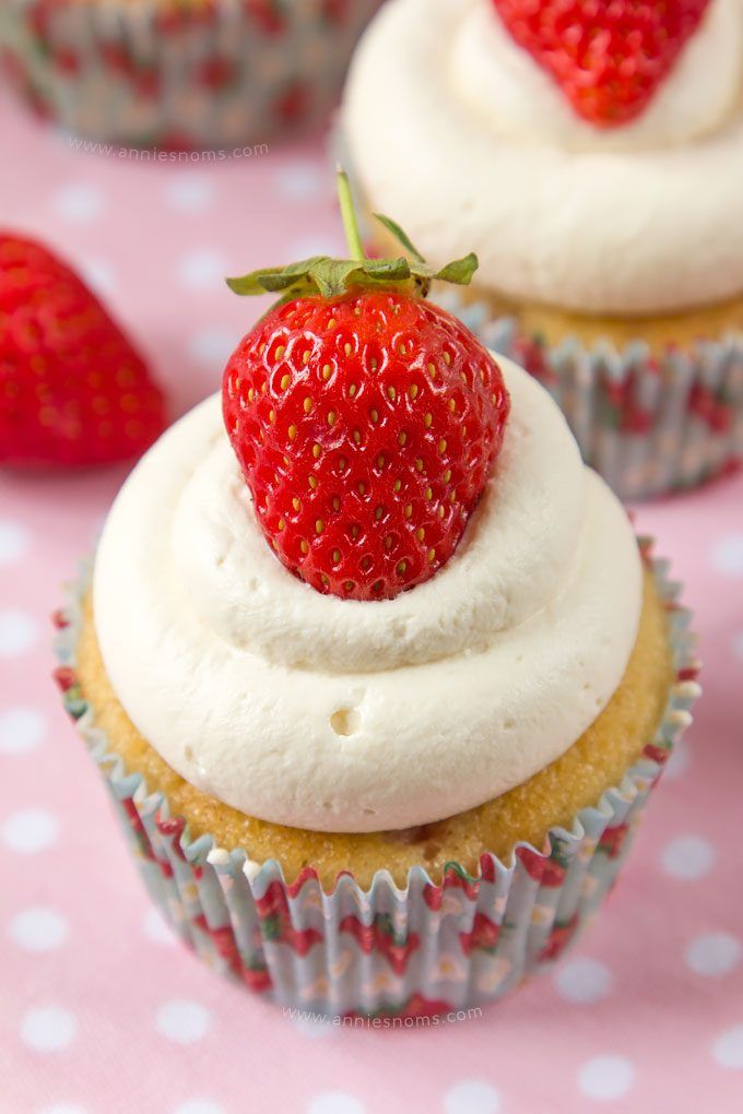 Soft cupcakes filled with chunks of fresh strawberries and topped with sweetened whipped cream and a whole strawberry make these Strawberries and Cream Cupcakes the perfect Summer treat!