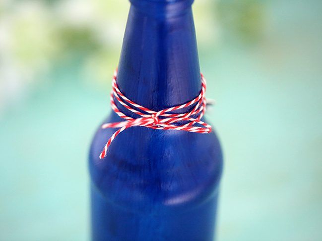 Make your own Red, White & Blue Glass Bottles with this DIY project.