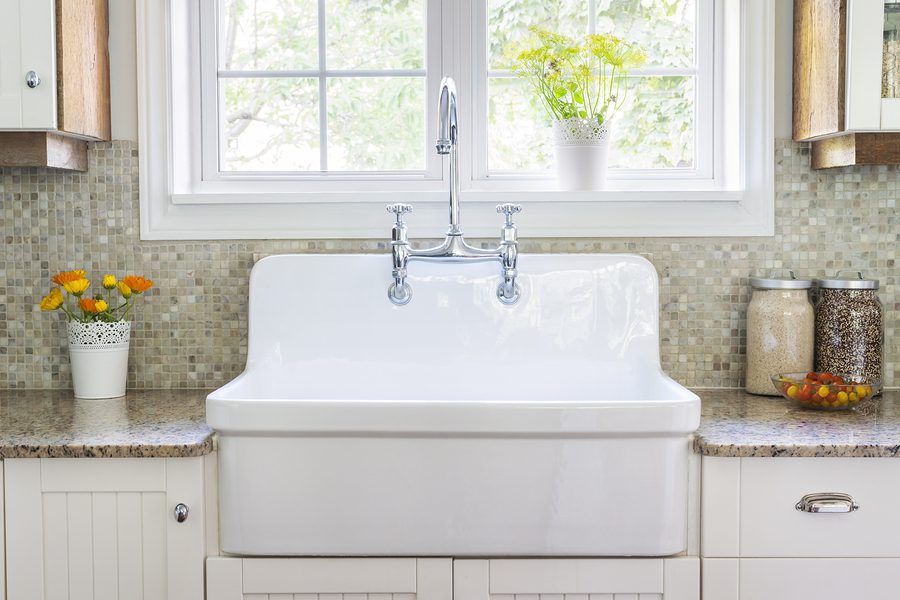 Kitchen interior with large rustic white porcelain sink and gran