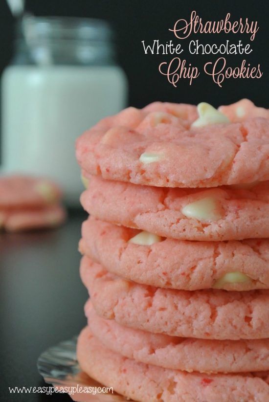 A stack of six pink cookies with a few visible white chips is in the foreground slightly out of frame on the right side. In the background are two more of these cookies, which are out of focus. The image is watermarked with www.easypeasypleasy.com in the bottom left corner.