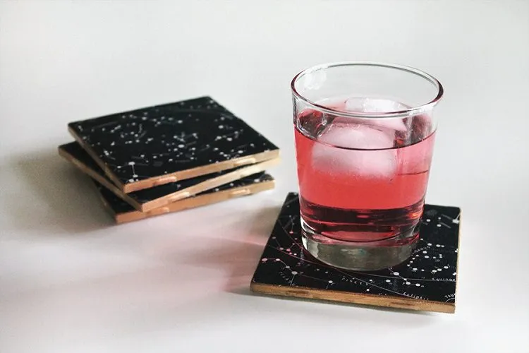 Cool Coasters Filled with Constellations and a glass filled with pink juice