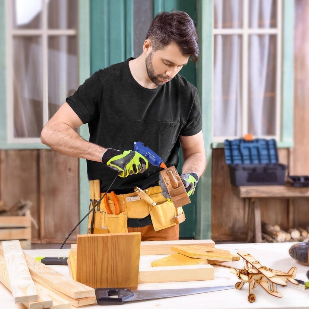 man using a hot glue gun