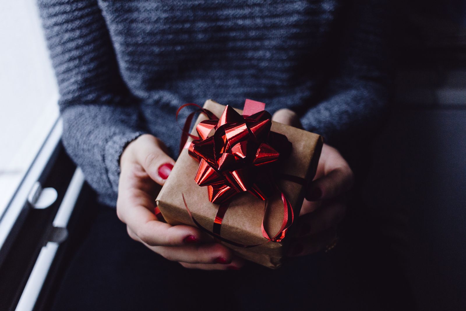 woman holding a small box of gift