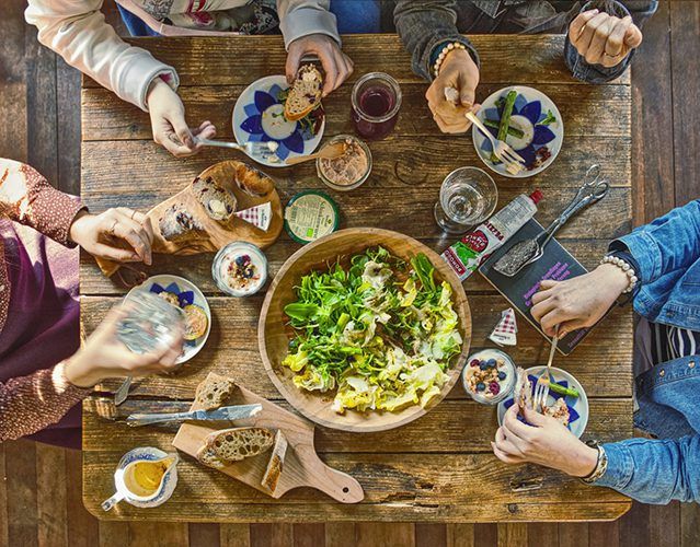 people eating salad at a table