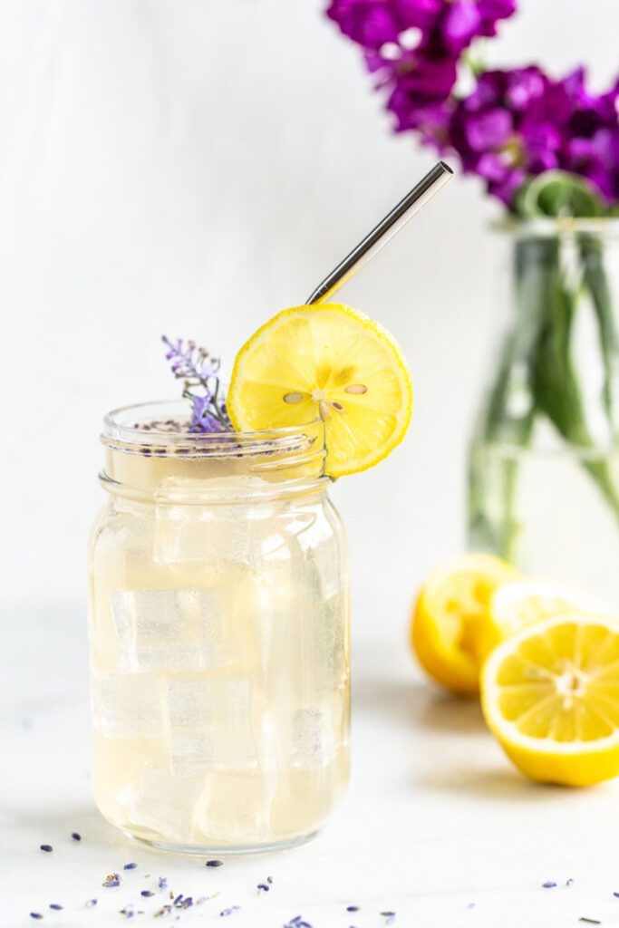 vodka lemonade with lavender and lemons coming out of cup