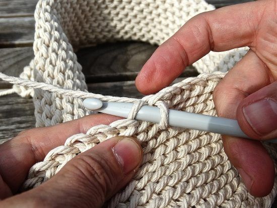 Hands working on a crochet project