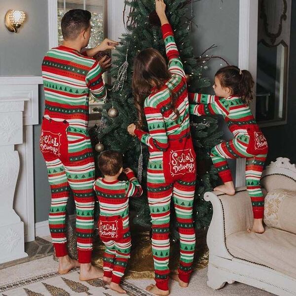 Pajamas that match - a family facing the Christmas tree