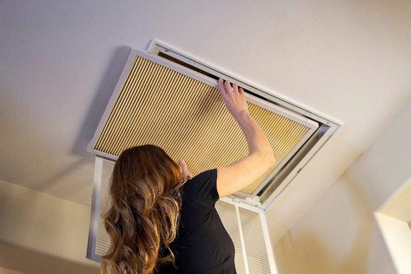 woman fixing air filter