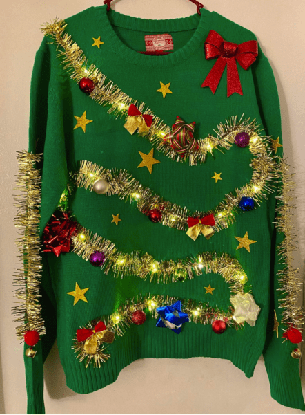 A Lights up ugly Christmas sweater with ornament